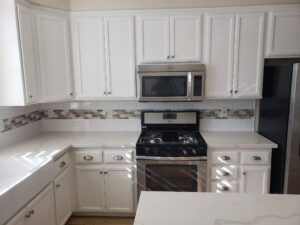 White Carrera Quartz Fabrication & Installation with Full Backsplash Subway Tiles & Accent Liner